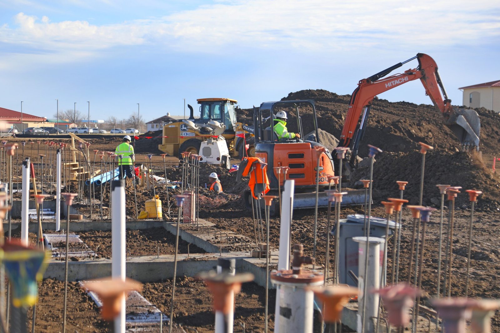 Alt Tag: Military construction site with crews and heavy equipment performing excavation and foundation work on a U.S. installation.